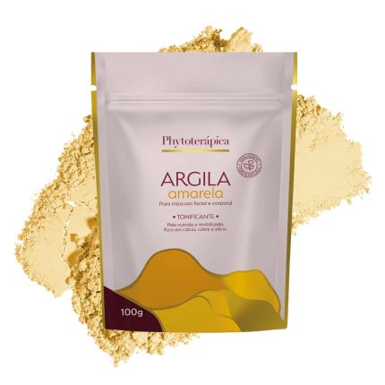 Embalagem de 100g da Argila Amarela Tonificante da Phytoterápica, disposta sobre uma porção da mesma argila em pó. O fundo é branco e o rótulo informa que o produto promove uma pele nutrida e revitalizada, sendo rica em cálcio, cobre e silício.