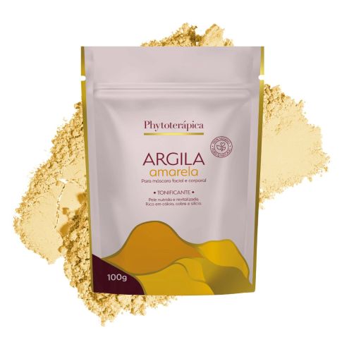 Embalagem de 100g da Argila Amarela Tonificante da Phytoterápica, disposta sobre uma porção da mesma argila em pó. O fundo é branco e o rótulo informa que o produto promove uma pele nutrida e revitalizada, sendo rica em cálcio, cobre e silício.